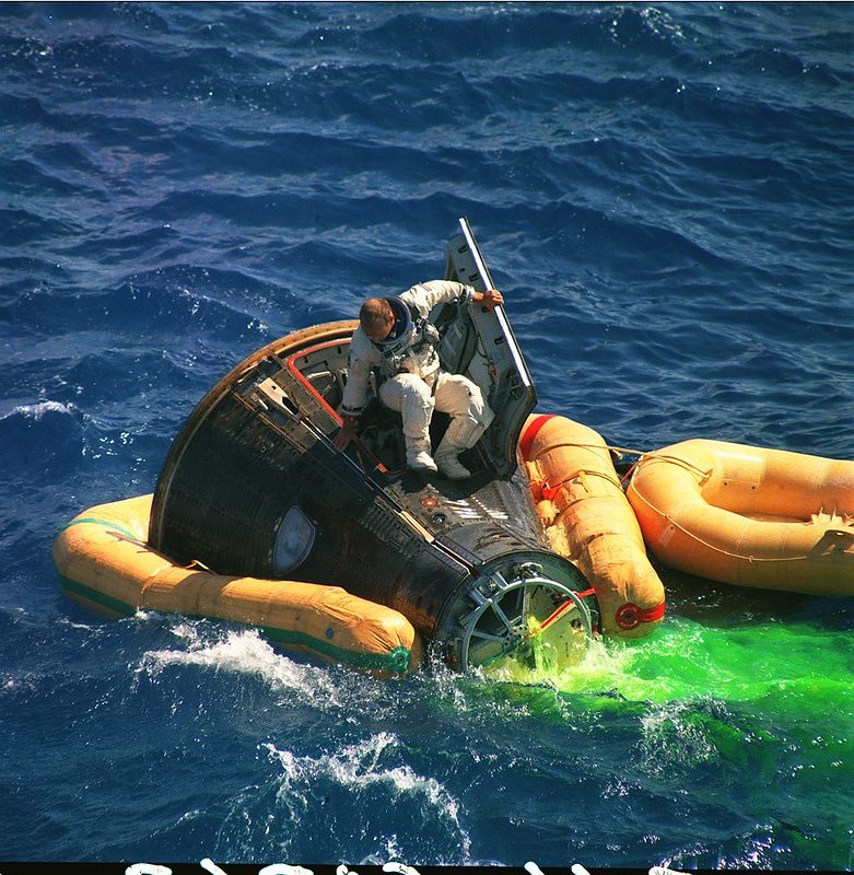 Gemini 11 astronaut after landing on top of capsule
